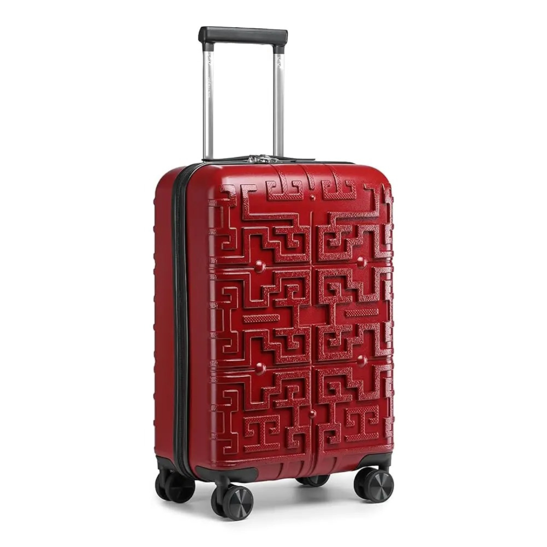 Red hard-shell suitcase with a raised geometric pattern, featuring a telescopic handle and 360° spinner wheels for easy movement.