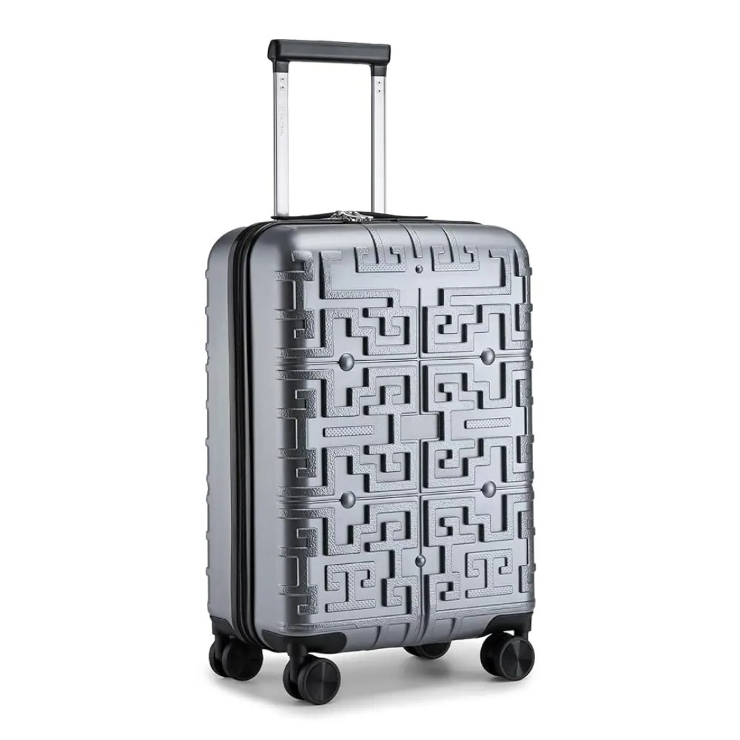 Silver hard-shell suitcase with a raised geometric pattern, featuring a telescopic handle and 360° spinner wheels for optimal manoeuvrability.