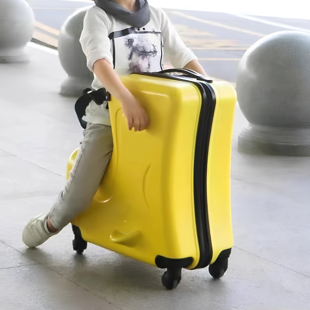 Child sitting on a yellow animal-shaped suitcase, showcasing its fun and practical design — perfect for comfortable travel.